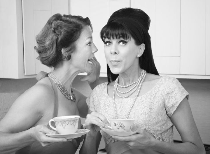 1960s style women gossiping in a kitchen - black and white photo