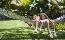 boy and girl swinging on outdoor hammock